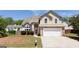 Charming two-story home with a stone veneer and a well-manicured front yard under a clear blue sky at 2805 Topaz Rd, Riverdale, GA 30296