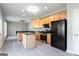 Modern kitchen with stainless steel appliances and island, adjacent to bright living area at 2805 Topaz Rd, Riverdale, GA 30296