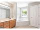Main bathroom features a soaking tub, double vanity, and tile floor at 2805 Topaz Rd, Riverdale, GA 30296