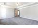 Main bedroom with plush carpet, neutral paint, and tray ceiling at 2805 Topaz Rd, Riverdale, GA 30296