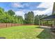 Expansive backyard with a well-maintained lawn and a wooden privacy fence at 5016 Brass Ct # 195, Locust Grove, GA 30248