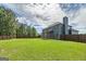 Large, fenced backyard with a lush lawn and covered patio, perfect for outdoor entertaining at 5016 Brass Ct # 195, Locust Grove, GA 30248