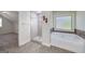 Bright bathroom with tub, shower, and wood-look floors, providing a spa-like feel at 5016 Brass Ct # 195, Locust Grove, GA 30248
