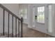 Bright entryway featuring wood-look floors and a staircase with wood and metal railings at 5016 Brass Ct # 195, Locust Grove, GA 30248