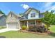 Attractive two-story home with brick and siding, a well-manicured lawn, and vibrant shrubbery at 5016 Brass Ct # 195, Locust Grove, GA 30248
