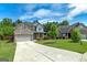 Inviting home featuring a brick facade, well-kept lawn, and a long driveway at 5016 Brass Ct # 195, Locust Grove, GA 30248