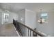 Upstairs hallway with natural light, a chandelier, and views of the downstairs area at 5016 Brass Ct # 195, Locust Grove, GA 30248