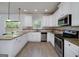 Modern kitchen featuring white cabinets, stainless appliances, and granite counters at 5016 Brass Ct # 195, Locust Grove, GA 30248