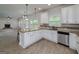 Open kitchen with granite counters and view to living room with fireplace at 5016 Brass Ct # 195, Locust Grove, GA 30248