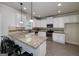 Open kitchen featuring granite countertops, stainless steel appliances, and barstool seating at 5016 Brass Ct # 195, Locust Grove, GA 30248