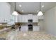 Well-lit kitchen showcasing granite countertops, stainless steel appliances, and ample white cabinetry at 5016 Brass Ct # 195, Locust Grove, GA 30248