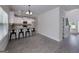 Bright kitchen dining area with barstool seating, light flooring, and backyard access at 5016 Brass Ct # 195, Locust Grove, GA 30248