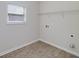 Bright laundry room with wood-look flooring, one window, plus washer and dryer hookups at 5016 Brass Ct # 195, Locust Grove, GA 30248