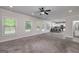 Open living room featuring backyard access, a ceiling fan, a kitchen dining area, and lots of natural light at 5016 Brass Ct # 195, Locust Grove, GA 30248