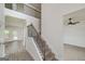Open staircase with metal and wood banister and view into multiple rooms at 5016 Brass Ct # 195, Locust Grove, GA 30248