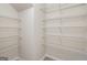 Spacious walk-in closet featuring white walls, light hardwood floors, and multiple wire shelving units at 5016 Brass Ct # 195, Locust Grove, GA 30248