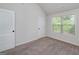 Bright bedroom featuring carpet flooring, natural light, and a closet at 5016 Brass Ct, Locust Grove, GA 30248