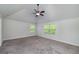 Large main bedroom with carpeted floors, vaulted ceilings, and natural light from large windows at 5016 Brass Ct, Locust Grove, GA 30248