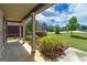 Covered front porch view, lush landscaping, and neighborhood streetscape at 5016 Brass Ct, Locust Grove, GA 30248