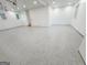 Large basement with gray epoxy floor, natural lighting and neutral walls, offering great potential for finishing at 3180 Lee Dr, Buford, GA 30518