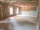 Unfinished basement with a concrete floor, framed walls, and natural lighting, ready to be transformed at 3180 Lee Dr, Buford, GA 30518