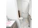 Well lit bathroom with marble tile, toilet, vanity and storage space at 3180 Lee Dr, Buford, GA 30518