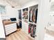 Spacious walk-in closet with custom organizers, drawers, shelving, next to the bathroom at 3180 Lee Dr, Buford, GA 30518