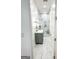 Modern bathroom with marble floors, vanity with gold fixtures, and a glass shower at 3180 Lee Dr, Buford, GA 30518