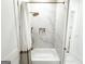 Modern bathroom with white marble tiles, a shower with a rainfall showerhead, and stylish fixtures at 3180 Lee Dr, Buford, GA 30518