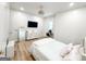 Bright bedroom with hardwood floors, TV, vanity, plush bedding, and modern lighting at 3180 Lee Dr, Buford, GA 30518