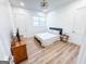 Cozy bedroom with hardwood floors, a window, and an open doorway at 3180 Lee Dr, Buford, GA 30518
