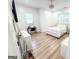 Bright bedroom features hardwood floors, large windows, desk, and a decorative ceiling fan at 3180 Lee Dr, Buford, GA 30518