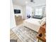 Bright bedroom boasts a large bed, vanity, sitting area, and a decorative accent rug at 3180 Lee Dr, Buford, GA 30518