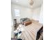 Bonus room featuring natural light, neutral walls, wood floors, and a sofa for relaxation and enjoyment at 3180 Lee Dr, Buford, GA 30518