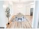 Bright dining room with wood floors, chandelier, and white chairs at 3180 Lee Dr, Buford, GA 30518