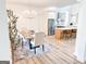 Bright dining area featuring chandelier, light wood floors, and views of the kitchen at 3180 Lee Dr, Buford, GA 30518