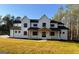 Stunning two-story modern farmhouse with black trim and a welcoming covered porch at 3180 Lee Dr, Buford, GA 30518
