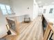 Second floor hallway with wood flooring, modern railings, and natural light at 3180 Lee Dr, Buford, GA 30518