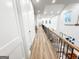 Upstairs hallway with modern railings overlooks the foyer at 3180 Lee Dr, Buford, GA 30518