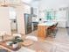 Bright kitchen boasts stainless steel appliances, wooden island with barstools, and modern accents at 3180 Lee Dr, Buford, GA 30518