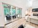 Bright living room with wood floors, fireplace, and large sliding doors to an outdoor living space at 3180 Lee Dr, Buford, GA 30518