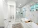 Marble tiled bathroom with soaking tub, glass shower, and a separate toilet area at 3180 Lee Dr, Buford, GA 30518