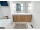 The bathroom offers double sinks, sleek lighting and marble floors and walls at 3180 Lee Dr, Buford, GA 30518