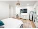This is the Main bedroom with a large TV, ensuite, light floors and neutral decor at 3180 Lee Dr, Buford, GA 30518