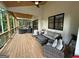Spacious outdoor porch with ceiling fan and comfortable seating area with wooded view at 3180 Lee Dr, Buford, GA 30518