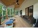 Large, covered porch with ample seating and outdoor furniture for relaxation and enjoyment at 3180 Lee Dr, Buford, GA 30518