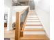 Staircase with wooden steps, black metal railing, and white risers at 3180 Lee Dr, Buford, GA 30518