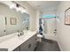 Stylish bathroom featuring modern fixtures, gray vanity, a large mirror, and shower/tub combo with tile at 227 Wet Wood Ct, Fairburn, GA 30213