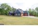 Stylish home with a large, manicured lawn and an attached two-car garage, offering both convenience and curb appeal at 227 Wet Wood Ct, Fairburn, GA 30213