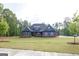 Inviting single-story residence with a well-kept lawn, lovely stone accents, and a cozy front porch at 227 Wet Wood Ct, Fairburn, GA 30213